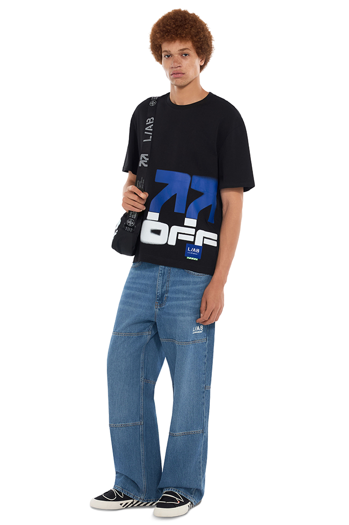L/AB c/o Off-White Men's Off Stacked Black T-Shirt with blue graphic and baggy skate jeans.