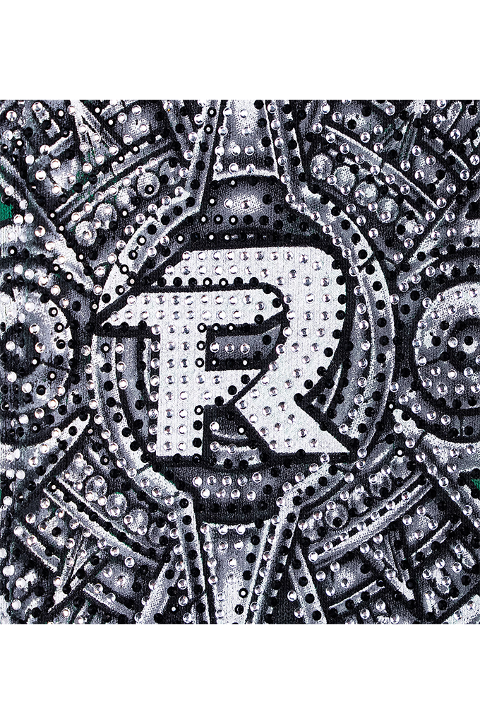 A close-up of a black, white, and gray sequined design featuring a large stylized letter 'R' in the center, surrounded by intricate circular and geometric patterns of rhinestones.