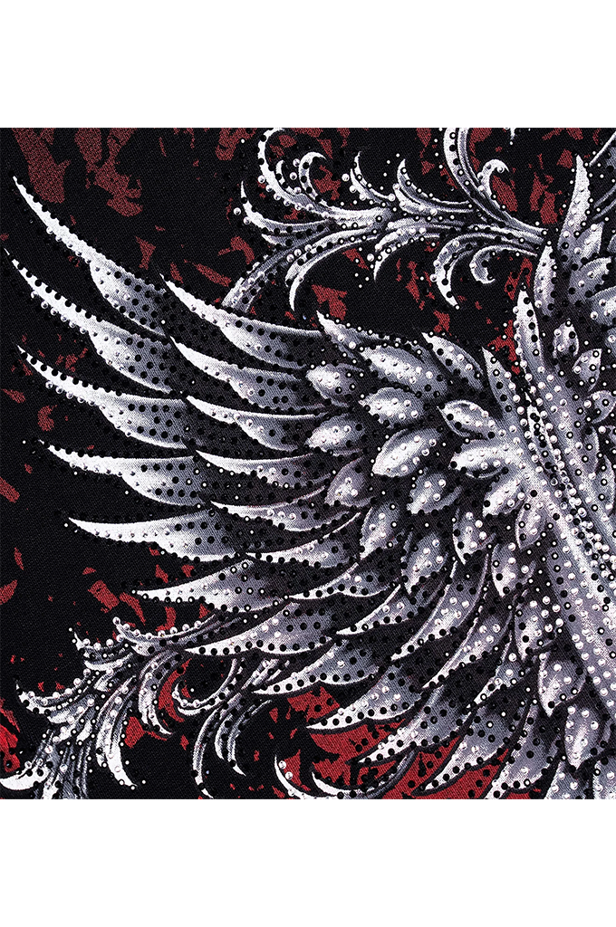 A close-up of a patterned fabric featuring a large silver and white wing design with black halftone dots, set against a black background with red splatter accents.