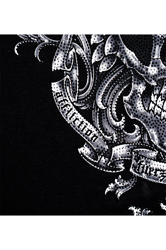 A close-up of a black garment featuring a detailed white graphic print with a skull, ornate scrollwork, and banners with gothic-style text.