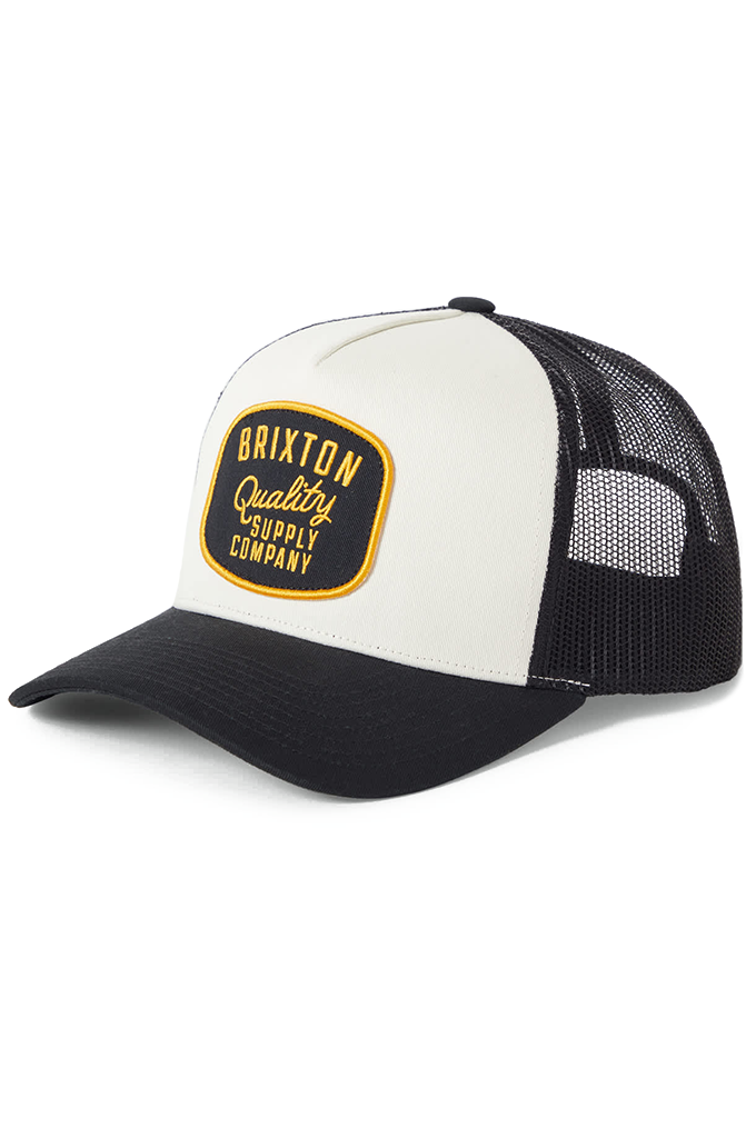 Brixton Hubal NetPlus Trucker Hat in black and off-white, featuring an embroidered "Brixton Quality Supply Company" patch on the front panel.