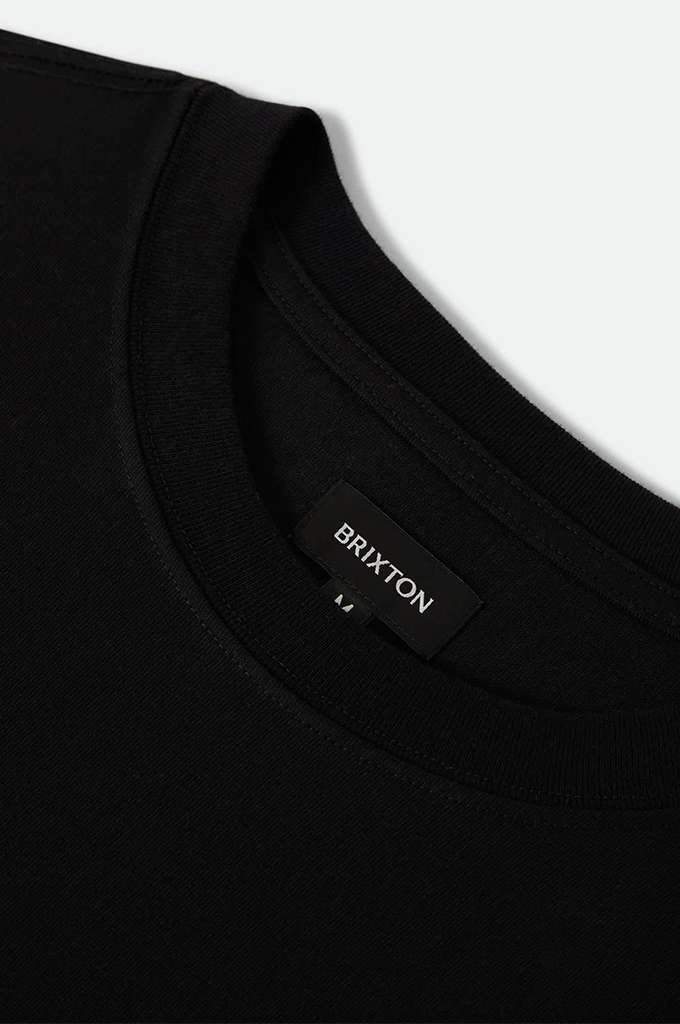 Close up of a black Brixton tag and neckline.