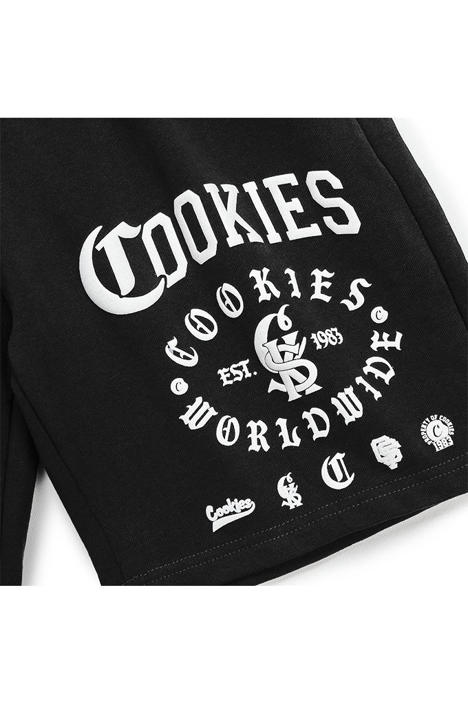 Close-up of a black garment featuring a large white 'Cookies Worldwide' graphic print with a central cookie logo and smaller white text and logos below.