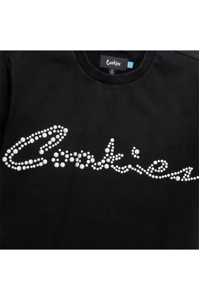 A close up of the chest of a Cookies black tee shirt on a white background with a pearl logo reading Cookies on the chest.