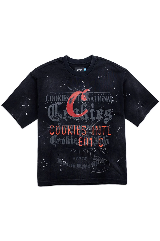 A black short-sleeve graphic t-shirt featuring distressed white splatter details and a central red and orange graphic print that reads 'Cookies National Chicks Cookies Intl 801 C' with a stylized 'C' logo, shown against a plain white background.
