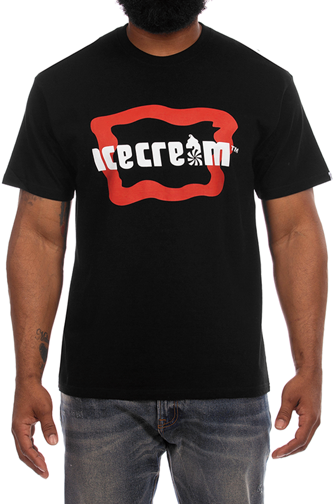 A man with a dark beard wears a black, short-sleeve graphic t-shirt by the streetwear brand ICECREAM. The front of the shirt features a large, wavy red rectangular outline containing the word "icecream" written in bold, white, lowercase letters. The letter "a" is styled with a graphic of a running dog silhouette over a spiral pattern. The man is cropped from the chest down and wears faded blue jeans. The photo is displayed within an online digital asset management or editing interface, with an informational