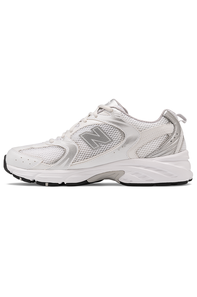 Side view of a white and grey New Balance running shoe on a white background. 