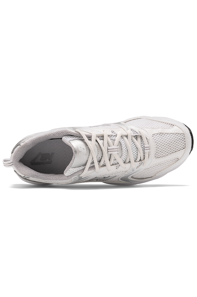 Top view of a white and grey New Balance running shoe on a white background. 