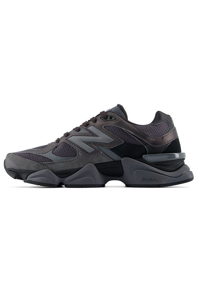 Profile view of a New Balance 9060 sneaker in a black and grey colorway, featuring its signature chunky, sculpted midsole.#color_black-grey-castlerock