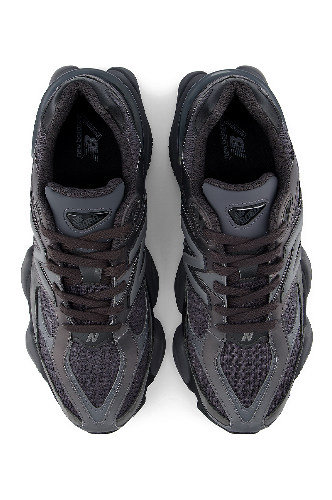 Top view of a New Balance 9060 sneaker in a black and grey colorway, featuring its signature chunky, sculpted midsole.#color_black-grey-castlerock