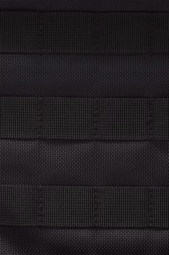 Close-up of a black textured fabric with horizontal stitched rows and a fine woven pattern.#color_black