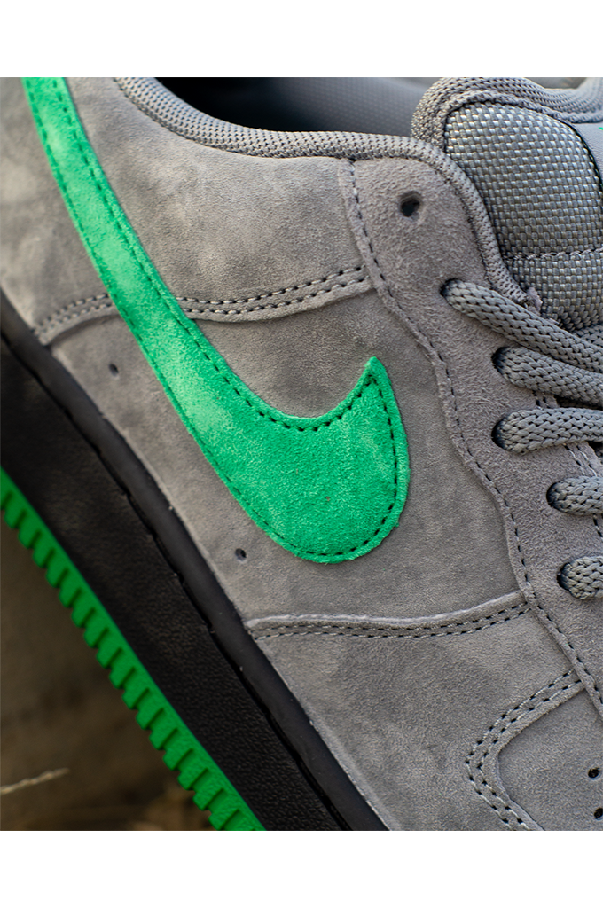 Close up of Nike SB Air Force 1 Low SE Nocturnal City Pack sneakers in cool grey suede with a court green swoosh and black midsole.