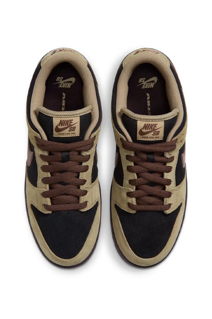 Top view of a Nike Dunk sneaker in a colorway of tan suede, black leather, and dark brown. The shoe features a tan suede upper, black leather overlays, dark brown laces, a dark brown Swoosh, and a dark brown gum sole, shown from a side profile view on a white background.