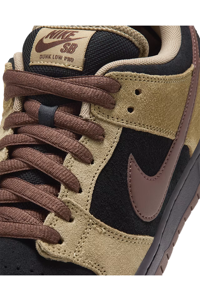 Close up view of a Nike Dunk sneaker in a colorway of tan suede, black leather, and dark brown. The shoe features a tan suede upper, black leather overlays, dark brown laces, a dark brown Swoosh, and a dark brown gum sole, shown from a side profile view on a white background.