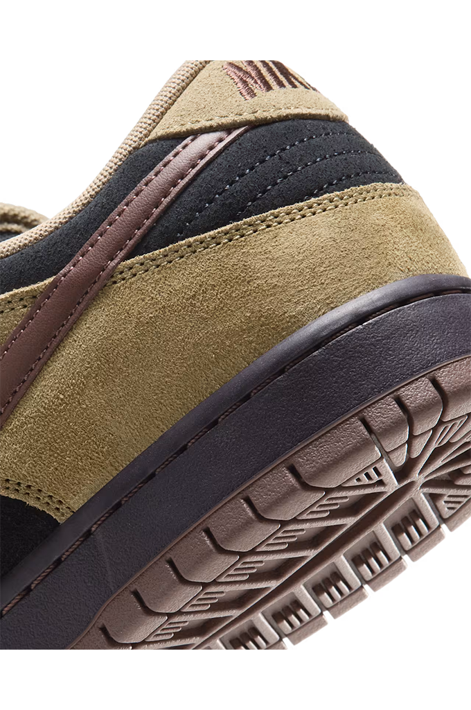 Back-up view of a Nike Dunk sneaker in a colorway of tan suede, black leather, and dark brown. The shoe features a tan suede upper, black leather overlays, dark brown laces, a dark brown Swoosh, and a dark brown gum sole, shown from a side profile view on a white background.