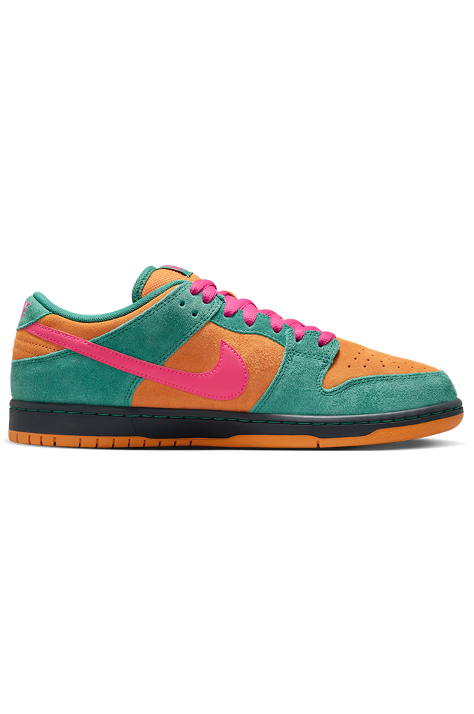 A low-top Nike sneaker in a vibrant color-blocked design featuring teal green suede, orange suede overlays, a bright pink Swoosh and laces, and a black and orange sole, shown against a plain white background.
