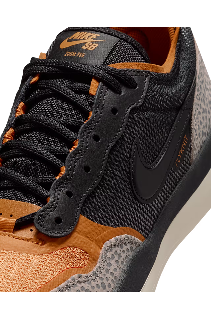 Close-up of a Nike SB Dri-FIT sneaker in black and orange, showing the textured mesh upper, black laces, black Swoosh, and orange accents.#color_cobblestone-black-monarch