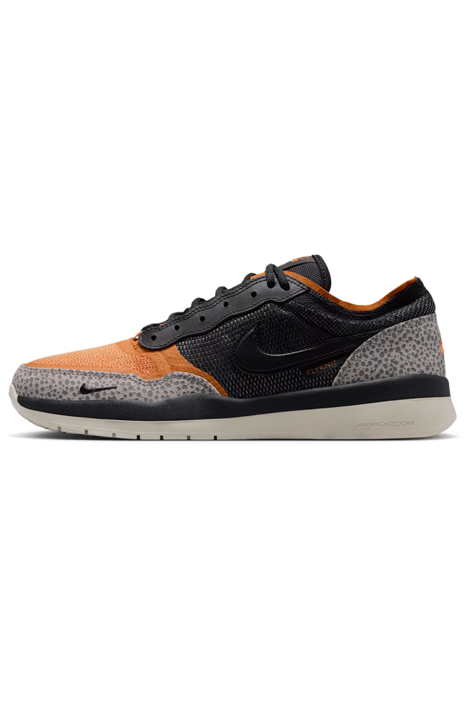 A Nike low-top sneaker in black, orange, and gray, shown from the side profile against a plain white background. #color_cobblestone-black-monarch