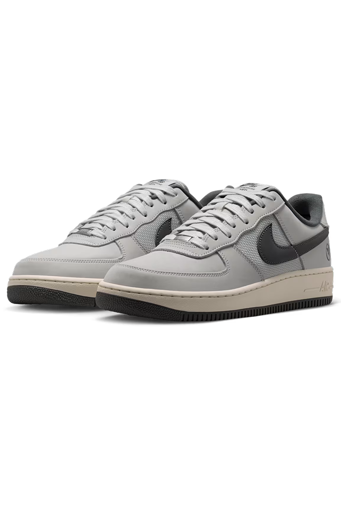 Pair of gray Nike SB sneakers with grey accents on a white background