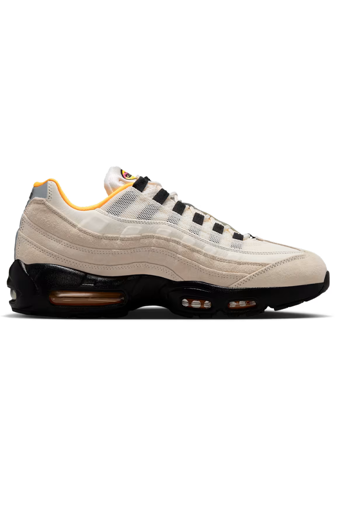 Beige and black Nike Air Max 95 sneaker with visible air cushioning and yellow accents, ideal for skateboarding and casual wear.