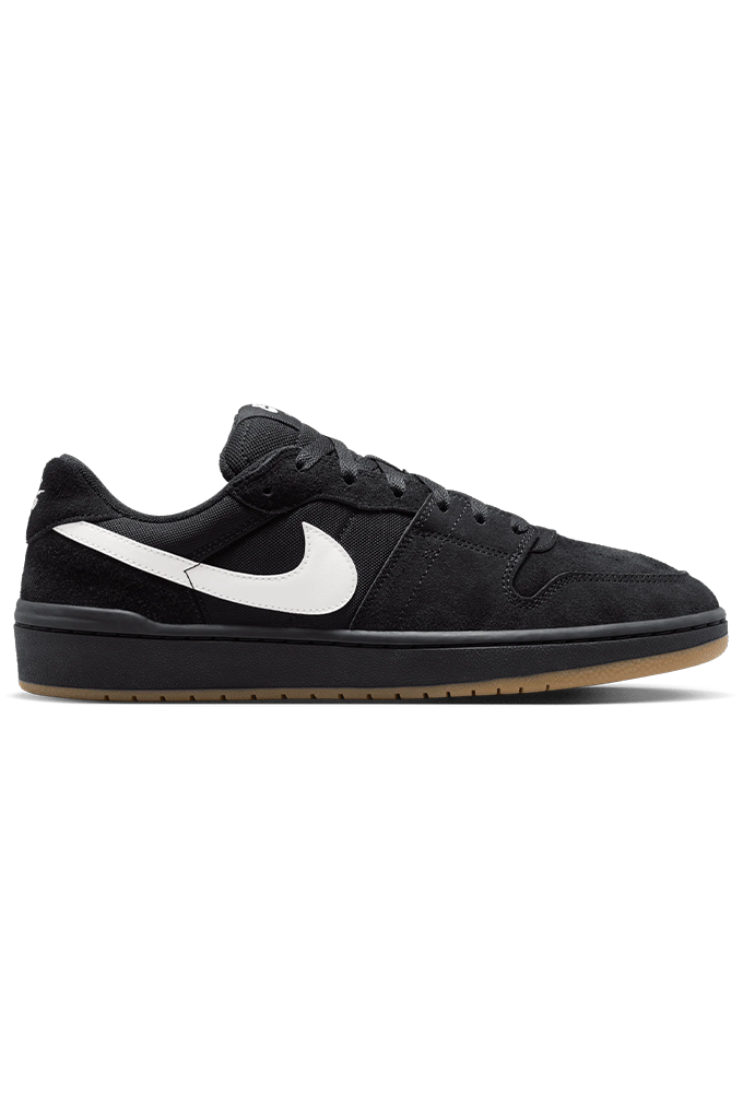 A black Nike low-top sneaker with a white Swoosh on the side, black laces, and a gum brown outsole, shown in profile against a plain white background.