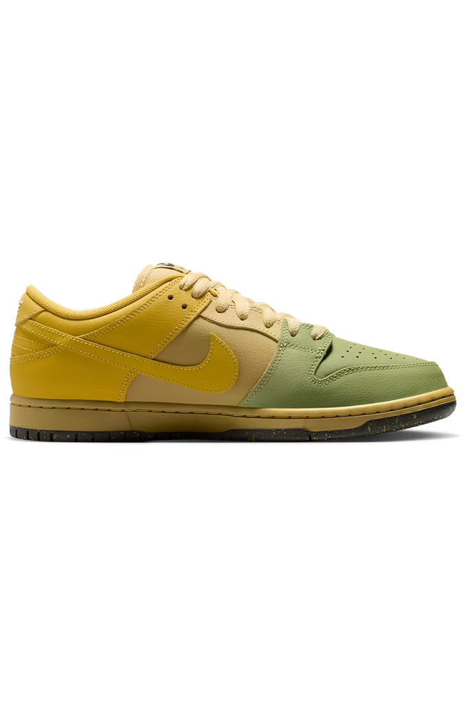 A Nike Dunk Low sneaker in a yellow, beige, and sage green colorway, shown from a side profile view against a plain white background.