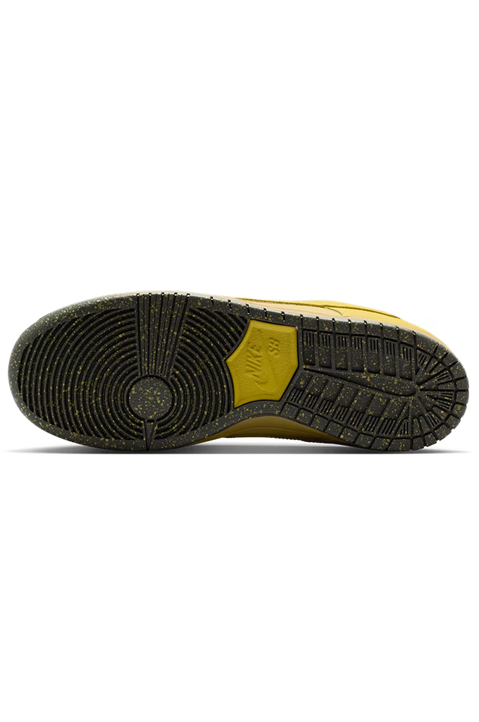 The outsole of a Nike sneaker, showing a black treaded rubber bottom with a yellow heel accent and a small embossed Nike logo.
