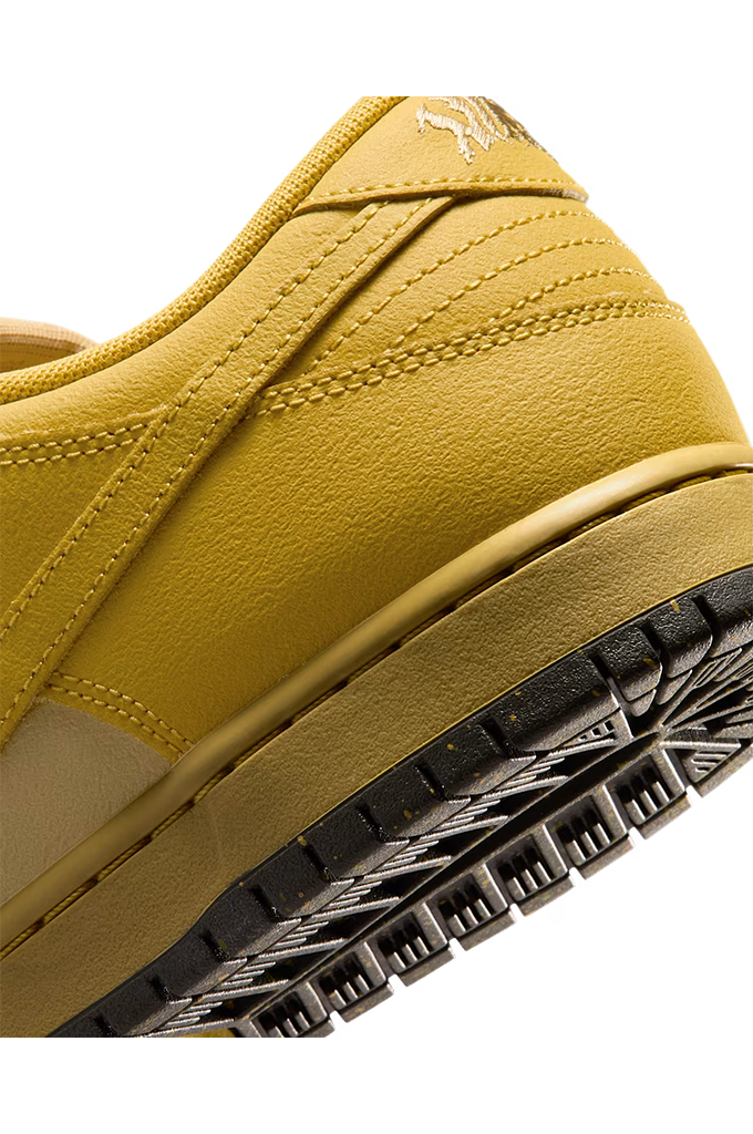 Close-up of a low-top sneaker showing the side panel, heel, stitching, and a black textured outsole against a white background.
