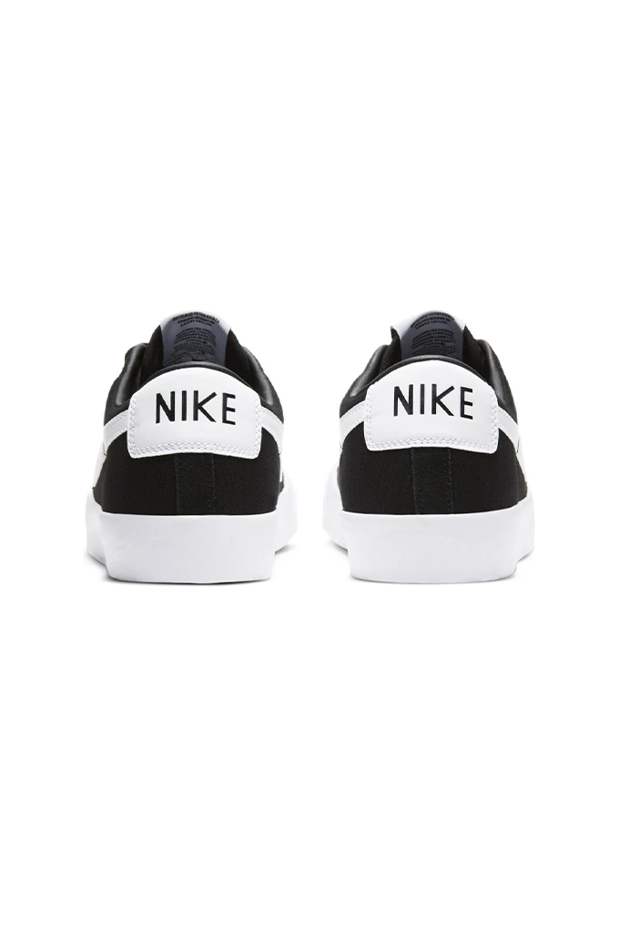 Back of a pair of Nike sneakers on a black background#color_black-white-black