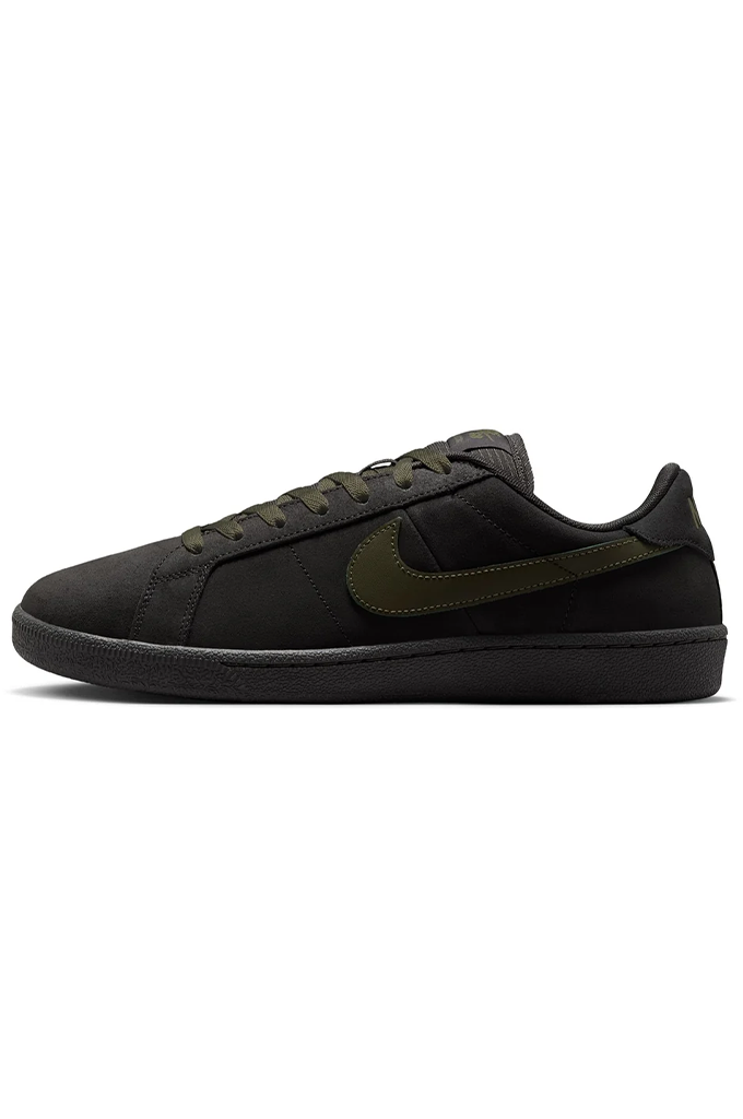 Side of Grey Nike SB shoe with olive green swoosh on a white background. 