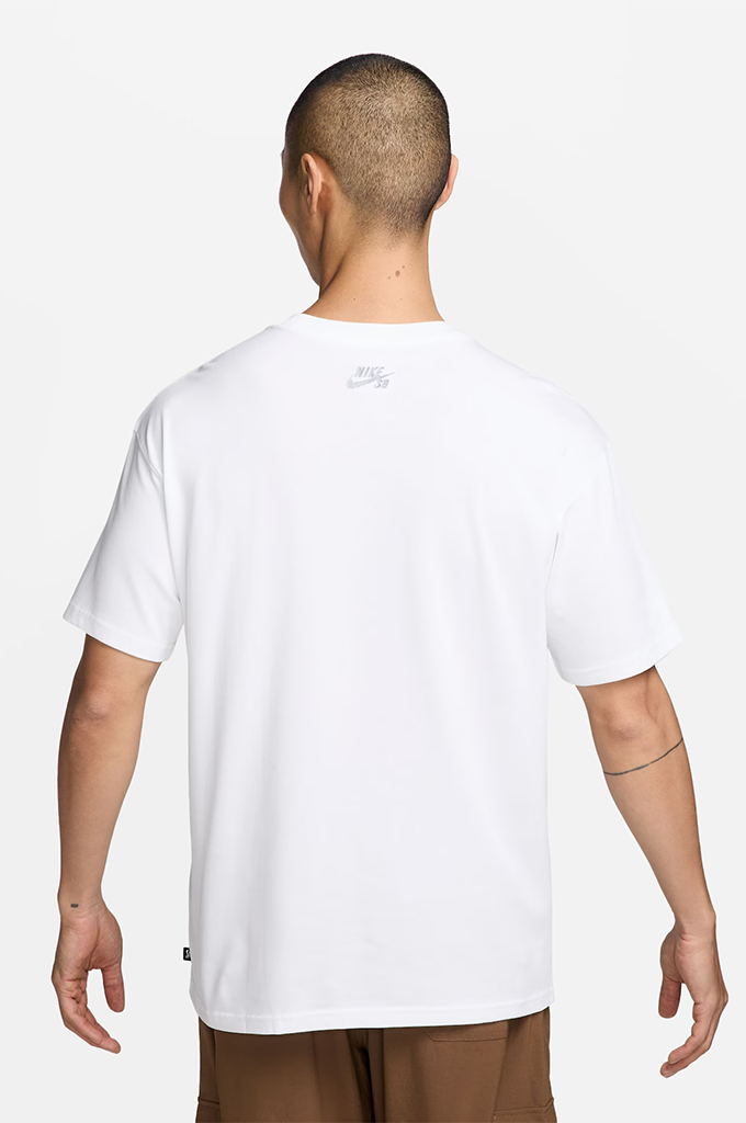 A man viewed from the back wearing a white short-sleeve Nike t-shirt and brown pants, set against a plain light gray studio background.#color_white
