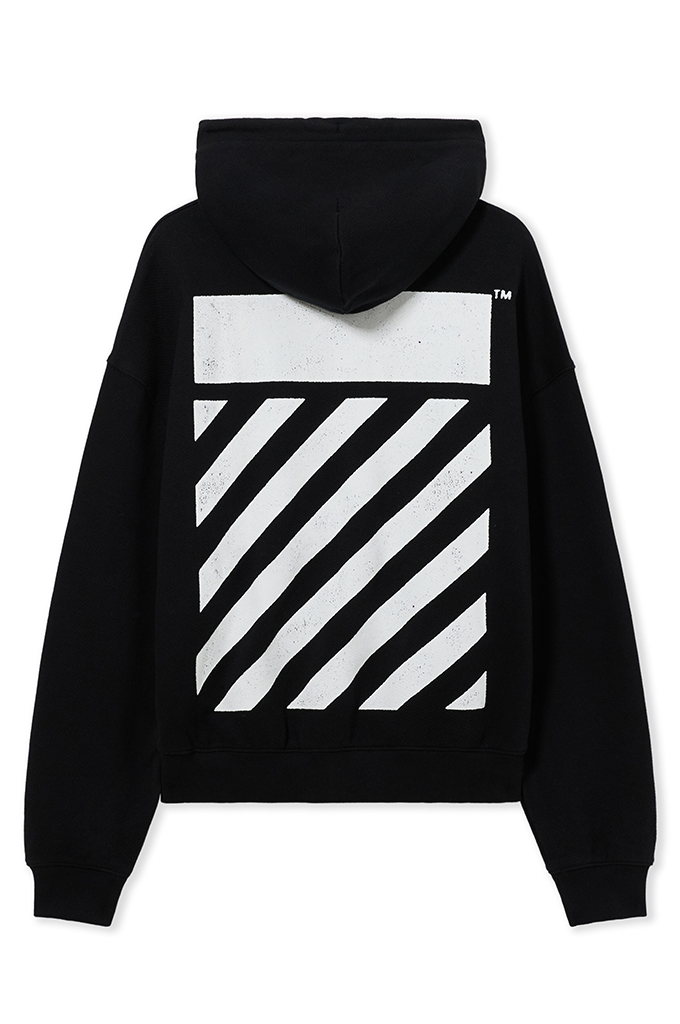Black pullover hoodie shown from the back, featuring a large white rectangular block and diagonal striped graphic on the back, with a small TM logo near the upper right shoulder.