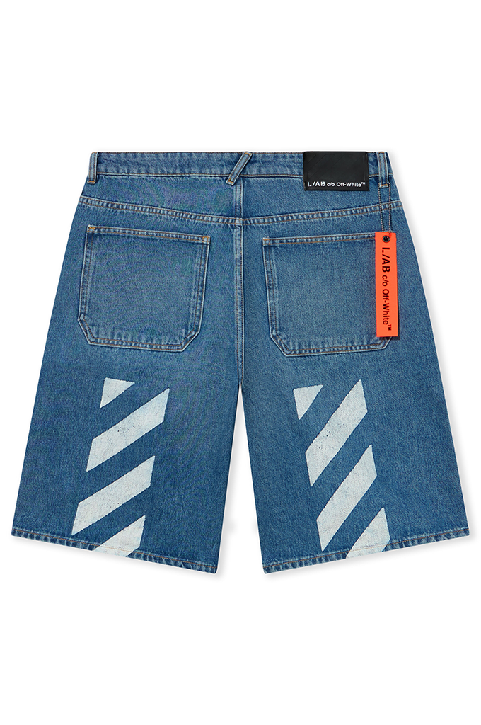 The back of denim jean shorts from Off-White laying flat on a white background. 