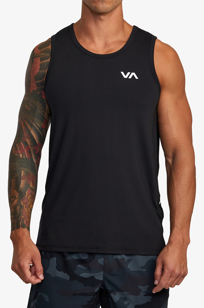A man wearing a black sleeveless athletic tank top with a small white VA logo on the left chest, paired with dark camouflage shorts, against a light gray studio background.