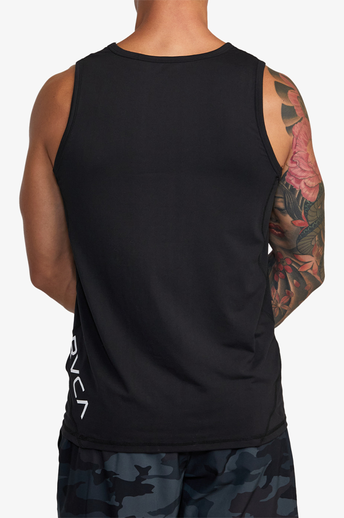Rear view of a man wearing a black sleeveless athletic tank top with a white vertical logo on the lower left side, paired with dark camouflage shorts against a light gray background.