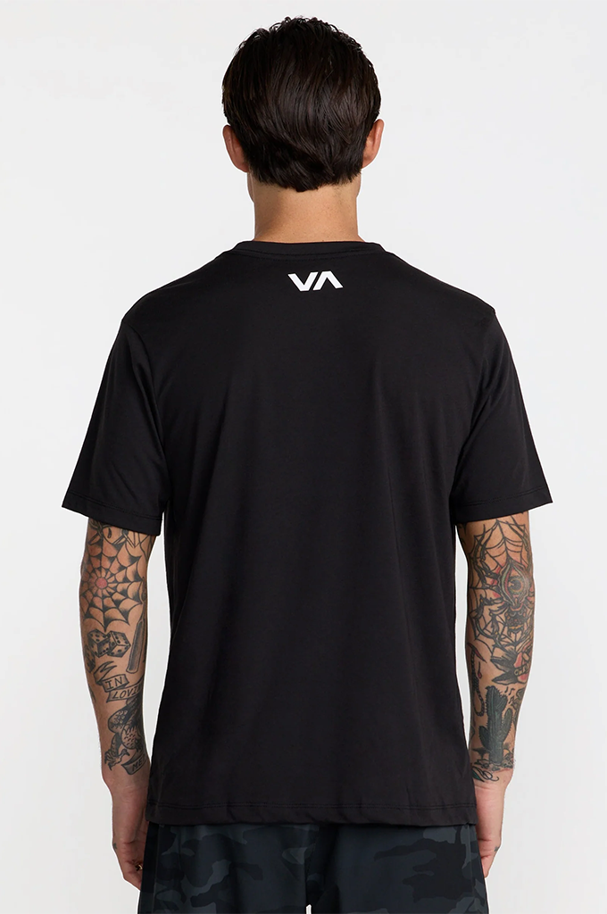 A man viewed from the back wearing a black short-sleeve t-shirt with a white 'VA' logo on the upper back, set against a plain light gray background.