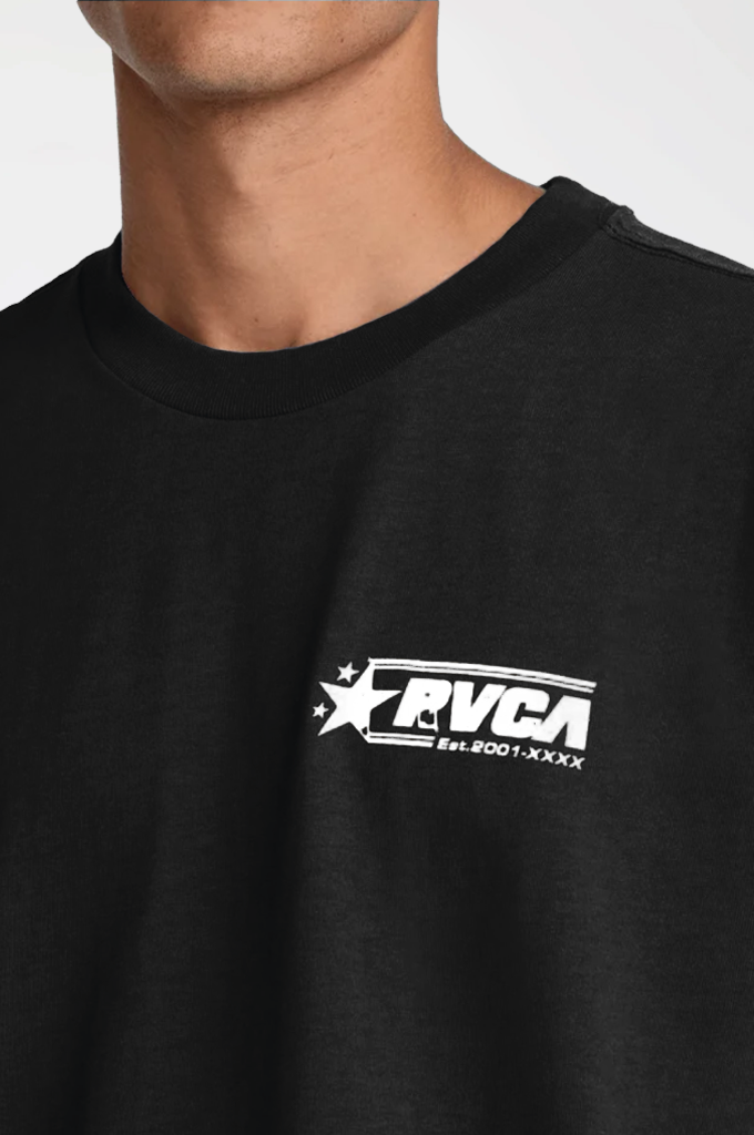 Close-up of a person wearing a black crewneck t-shirt with a white graphic logo on the left chest that reads 'RVCA EST.2001-XXXX'.