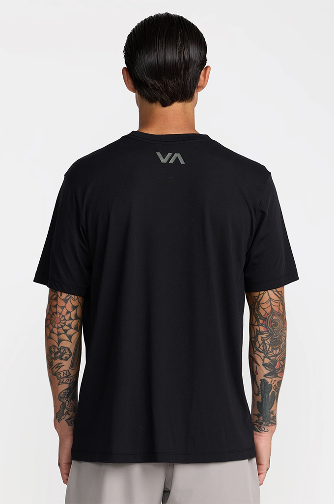 A man viewed from the back wearing a black short-sleeve t-shirt with a gray 'VA' logo on the upper back, paired with light gray pants, against a plain light gray background.#color_black
