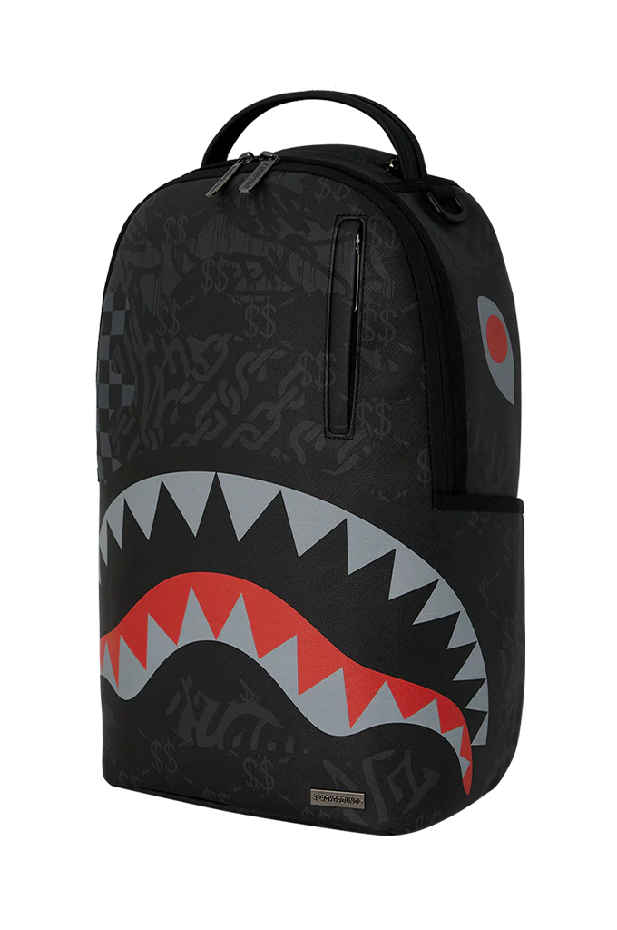A black Sprayground backpack featuring the iconic shark mouth graphic with red, gray, and white teeth, and a subtle graffiti-style pattern across the surface.