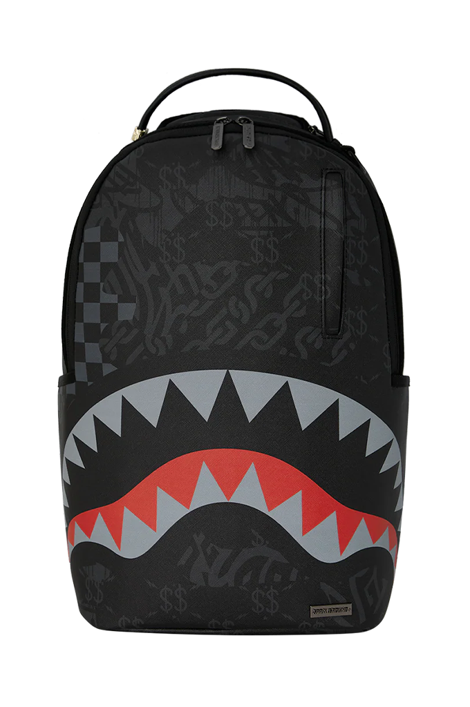 A black Sprayground backpack featuring the iconic shark mouth graphic with red, gray, and white teeth, and a subtle graffiti-style pattern across the surface.