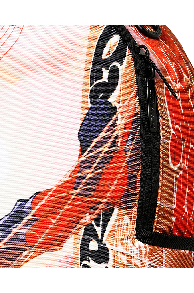 Close-up of a Spider-Man themed backpack featuring red and blue web-patterned fabric, black zipper details, and stylized spider graphics.