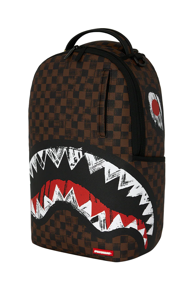 A brown and black checkered backpack featuring a large shark mouth graphic on the front with white, red, and black details, shown against a plain white background.