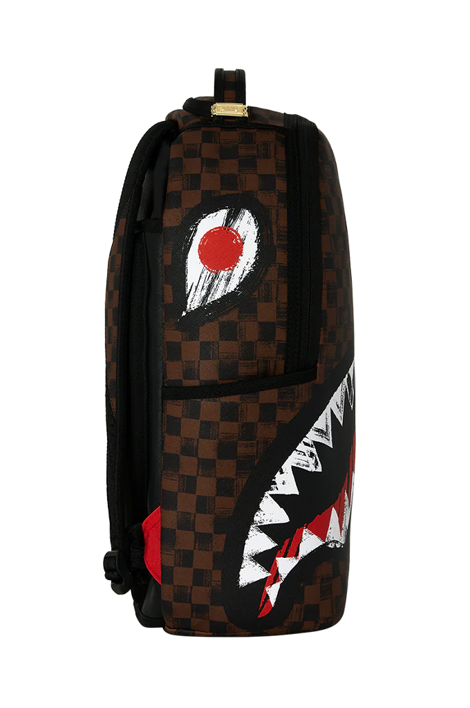 A dark brown and black checkered backpack featuring a shark mouth graphic on the front with white, red, and black details.