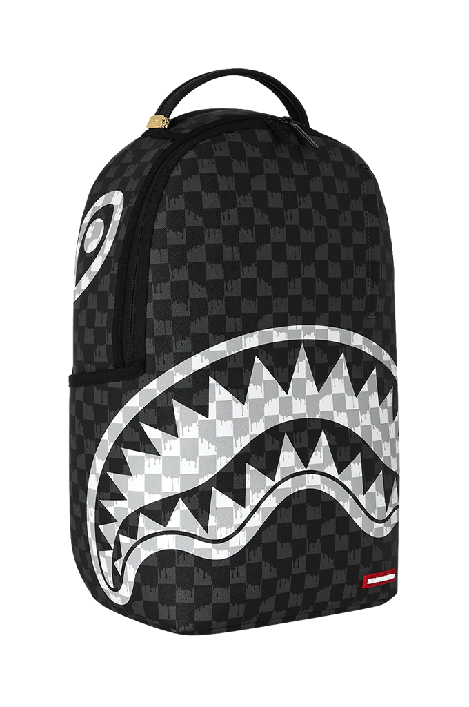 A black and gray checkered Shark Mouth backpack with a large white and gray shark mouth graphic on the front, featuring a top carry handle and a small red Sprayground logo patch.