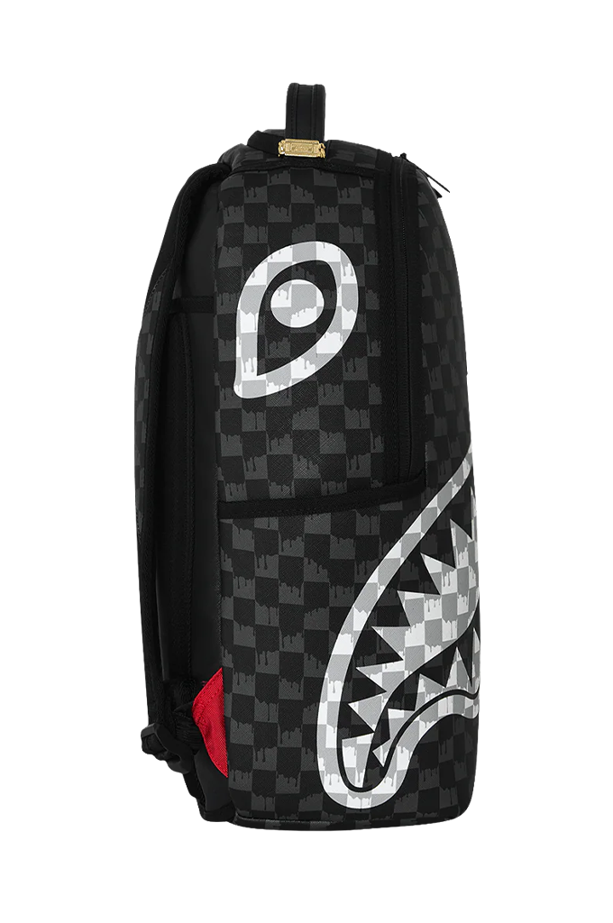 A black and gray checkered backpack featuring a large shark-mouth graphic in a gray and white checker pattern on the lower right, with a small red accent near the bottom left.