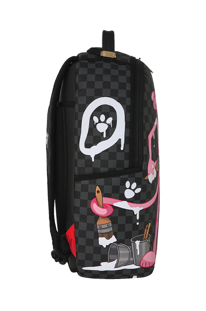 A black and dark gray checkered backpack featuring a white dripping paw print graphic, pink cartoon elements, and paintbrushes and paint cans on the front pocket, shown against a plain white background.