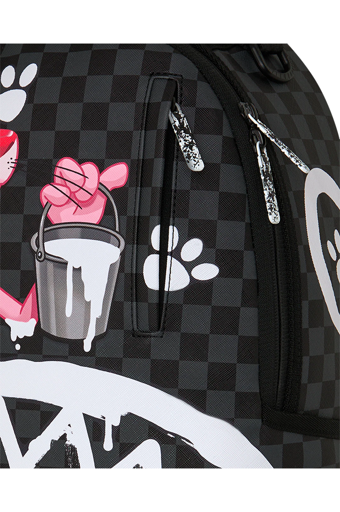 Close-up of a black and dark gray checkered backpack featuring a pink cartoon hand holding a dripping paint bucket, white paw prints, and silver zipper pulls.
