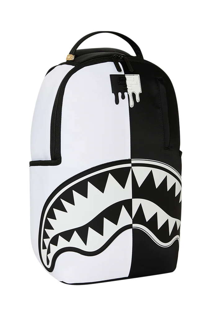 A white and black backpack featuring a large shark mouth graphic on the lower front, with black zippers and a black top handle, shown on a plain white background.