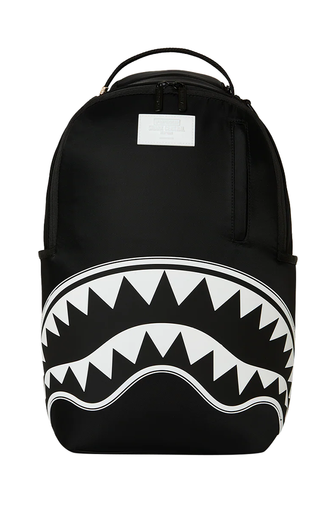 A black backpack featuring a bold white shark mouth graphic with sharp teeth across the lower front, shown against a plain white background.