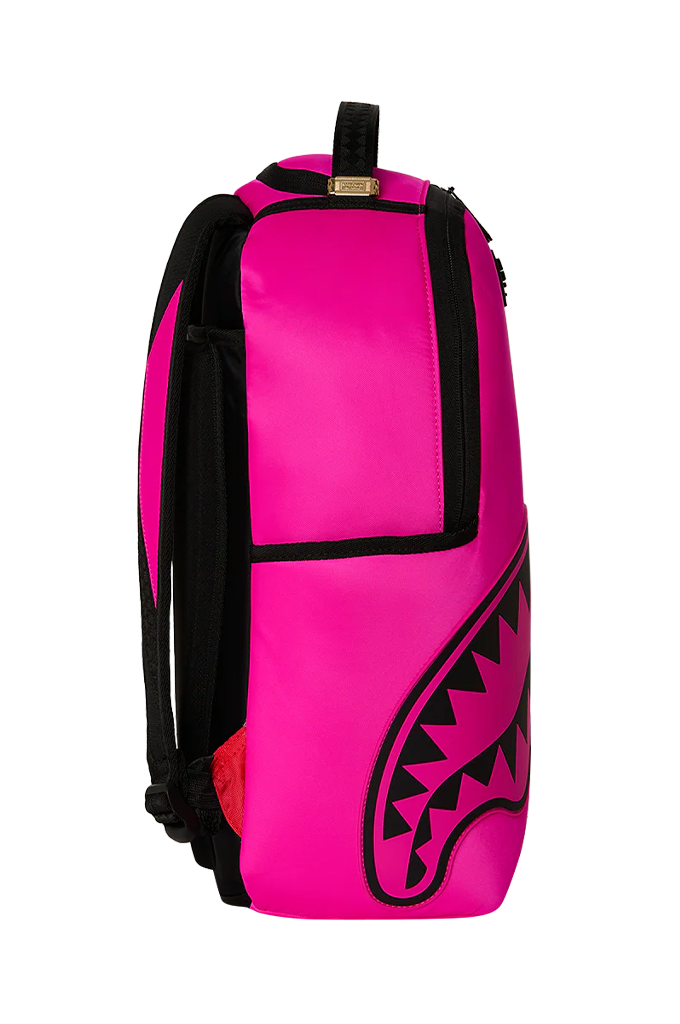 Bright pink backpack with black trim, black shoulder straps, and a large black shark-mouth graphic on the lower front, shown against a plain white background.